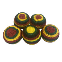 Five crocheted balls with a rasta pattern on a light gray background
