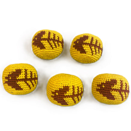 Five yellow and brown crochet footballs on a white background