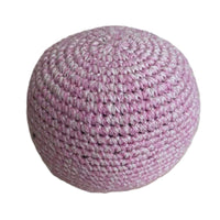 Pink crocheted ball on a white background