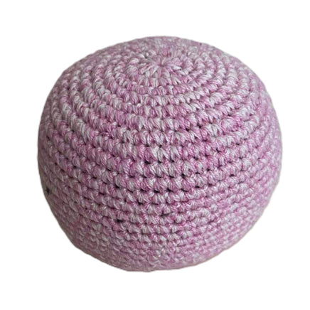 Pink crocheted ball on a white background